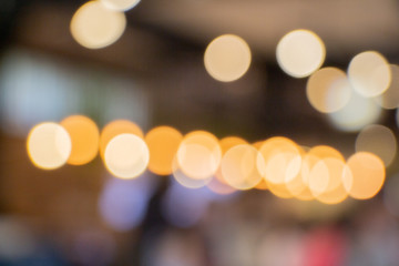 Fototapeta premium beautiful abstract blurred bokeh of orange lights indoor shop background.