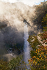 Fototapeta na wymiar wonderful view of kegon waterfall with fog and sun light in autumn nikko