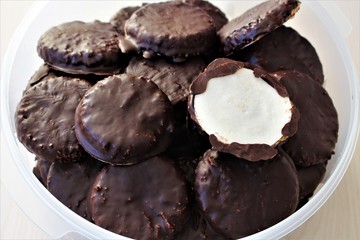 Box full of chocolate covered german Elisenlebkuchen. Homemade Christmas cookie bakery