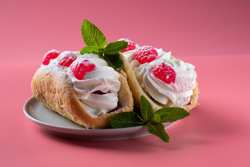 Airy raspberry cake in a plate on a pink background