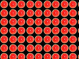  Seamless photo pattern of grapefruit slices on a black background. Seamless pattern for your design.
