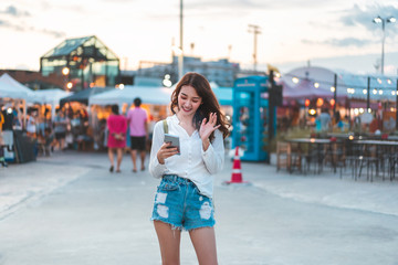 Young city backpack solo blogger asian woman use social network.