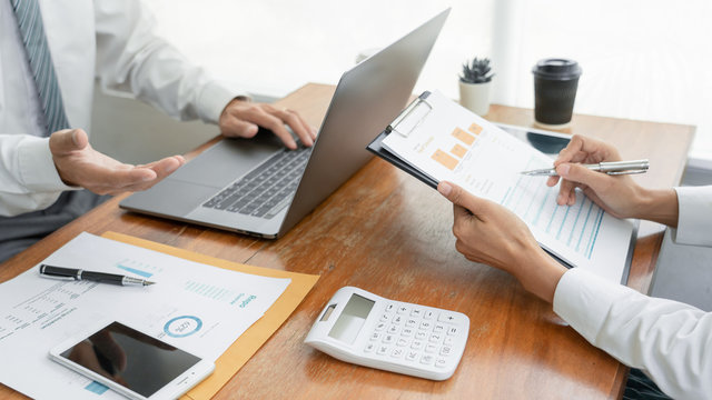 Business People Talking Discussing with coworker planning analyzing financial document data charts and graphs in Meeting and successful teamwork Concept.