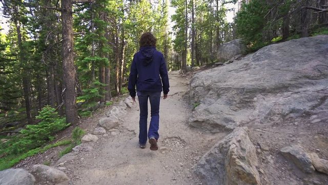 Slow motion woman hiking in the forest