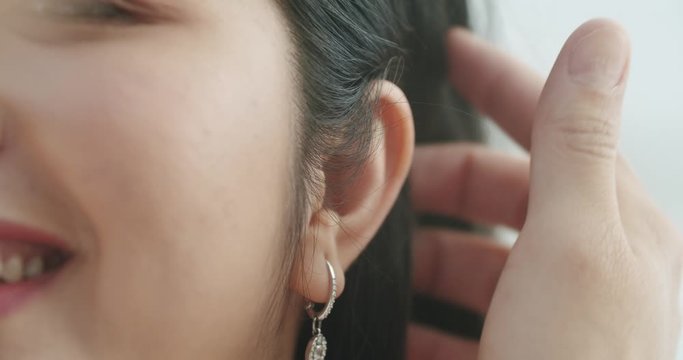 close up asian woman brush hair over ear