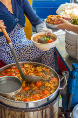 Woman cooking Vietnamese Bun Rieu noodle at street food vendor