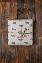  Wooden textured background. Gifts in Kraft packaging with ribbon.