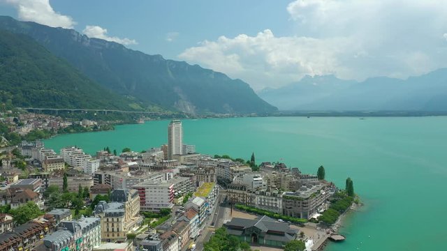 day time flight over montreux city center geneva lake famous bay aerial panorama 4k switzerland