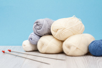 Fototapeta na wymiar Woolen yarn for knitting. Balls of natural wool yarn and knitting needles