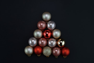 Collage of many Christmas balls in the form of a Christmas tree for the new year. Stylized christmas tree.