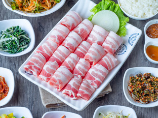 Set of raw fresh pork slide in white plate serve with many kind of vegetable.