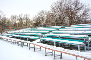 Snow covered tribune in a deserted park. Winter. Russia