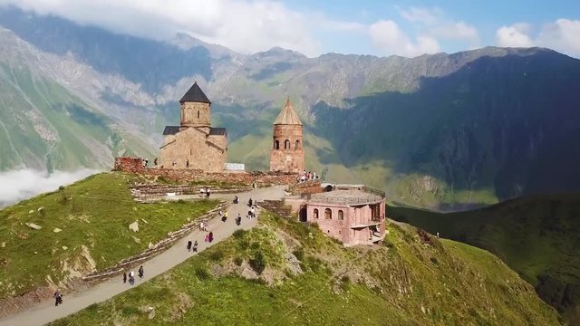 2019 - aerial approaching the Gergeti monastery and church overlooking the Caucasus mountains in the Republic of Georgia.