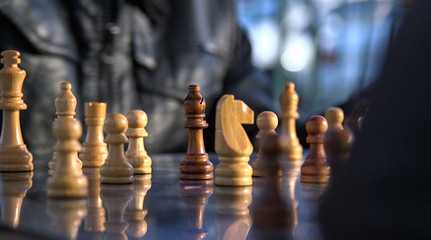 Chess board close up with black bishop in focus