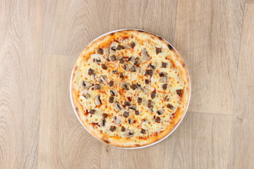 chicken pizza with vegetables and cheese on a wooden background