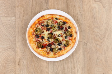 Pepperoni pizza with vegetables on a wooden background - salami