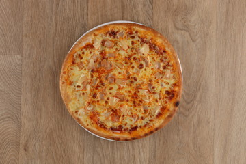 Margherita pizza with vegetables on a wooden background 