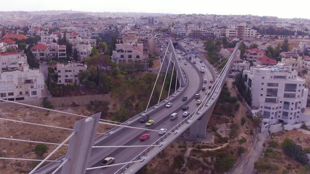 2019 - high aerial over the city of Amman, Jordan and Abdoun Bridge with vehicle traffic.