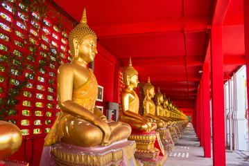Uthai Thani, Thailand - November, 30, 2019 : Row of golden sitting buddha statues in temple at Uthai thani province, Thailand