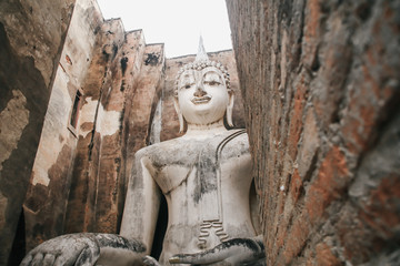 Ruins temple Sukothai historical park, Unesco world heritage, Thailand, the body to head part of the big buddha image at Wat Sri Chum in Sukhothai.