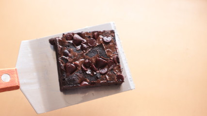 Chocolate brownies placed on a baking tray are beautifully arranged.