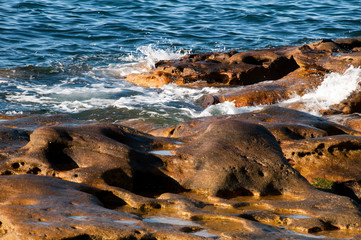 Sydney Australia, gentle waves breaking over rocks in Sydney Harbour
