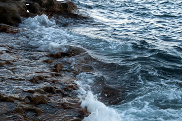 Sydney Australia, coastal scene of waves breaking and rushing over rocks 