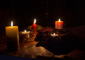  burning candle on the palms of an elderly woman.