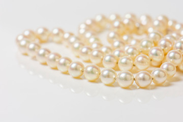 Close up of sphere natural pearl necklace on white background. Selective focus.