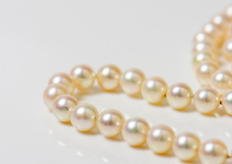 Close up of sphere natural pearl necklace on white background. Selective focus.