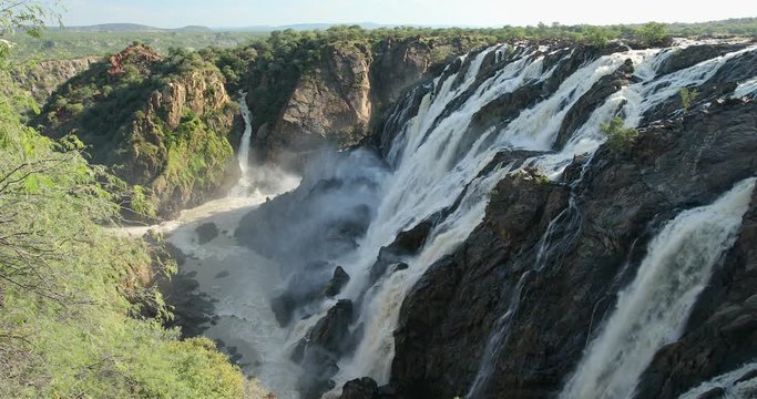 famous Ruacana waterfalls on the Kunene River, Northern Namibia border, Africa wilderness landscape, Waterfall is full of water after rain season.