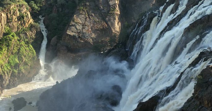 famous Ruacana waterfalls on the Kunene River, Northern Namibia border, Africa wilderness landscape, Waterfall is full of water after rain season.