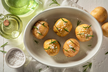 Preparation for tasty baked potatoes made of salt and rosemary