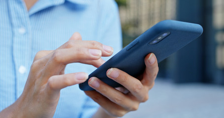 Close up of woman use of smart phone in city
