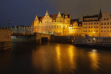 Fototapeta na wymiar Evening streets of old Gdansk, bridge over the main river, central tourist street called long market.