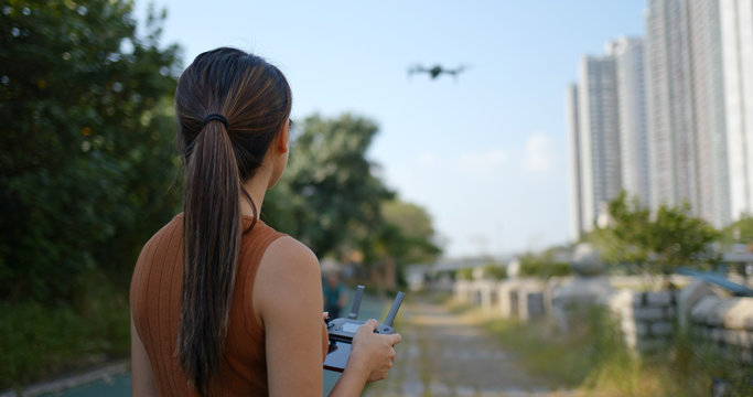 Woman control fly drone at outdoor