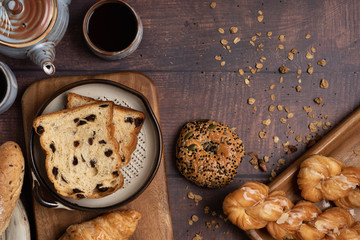 Fresh bread and Black Coffee on wood table,top view and horizontal.