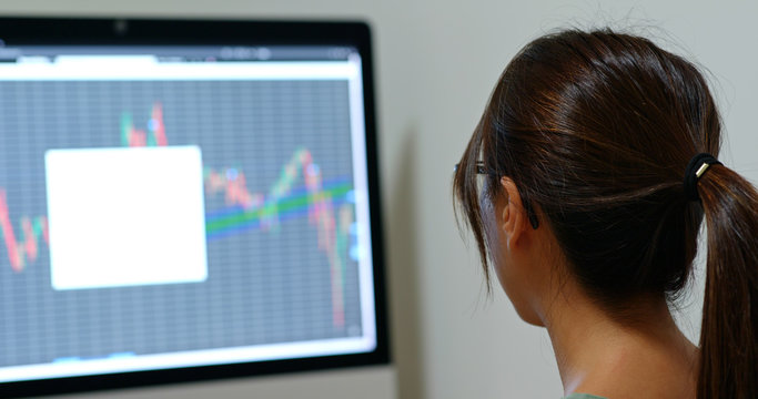 Woman study on stock market data - Powered by Adobe