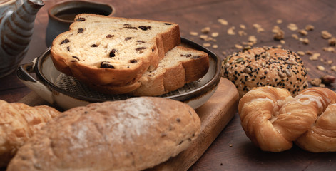 Fresh bread and Black Coffee on wood table.