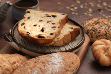 Naklejka premium bread and Black Coffee on wood table.