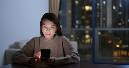 Young woman use of mobile phone at night