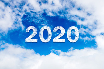 Naklejka na ściany i meble Sky cloud year 2021. Happy New year concept. 2021 cloud against the blue sky.Year 2021 symbol inscription on a background of blue sky from white smoke of clouds lit by a bright sun