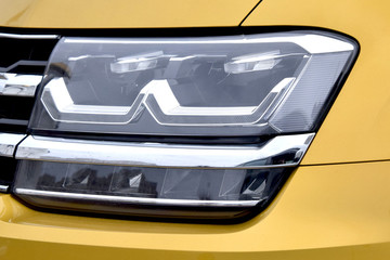 headlight of a modern car in gold color