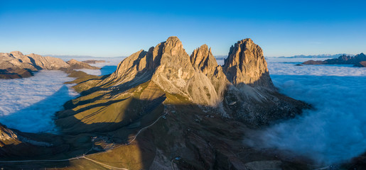 Aerial panorama of cloud sea at Sella mountain pass between the provinces of Trentino and South Tyrol, Dolomites