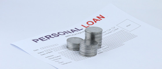 Personal loan application form with coins