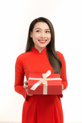 Fototapeta premium Asian girl with Vietnamese traditional dress holding gift box, Lunar New Year Greetings