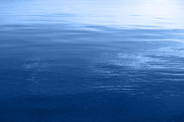 Blue water surface with ripples on the sea.