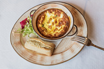 Baked omelet for breakfast with cutlery on the table. Livestyle.