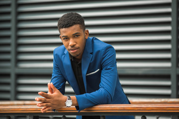 handsome young african man in a blue jacket