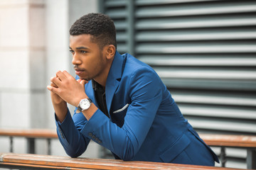 handsome young african man in a blue jacket